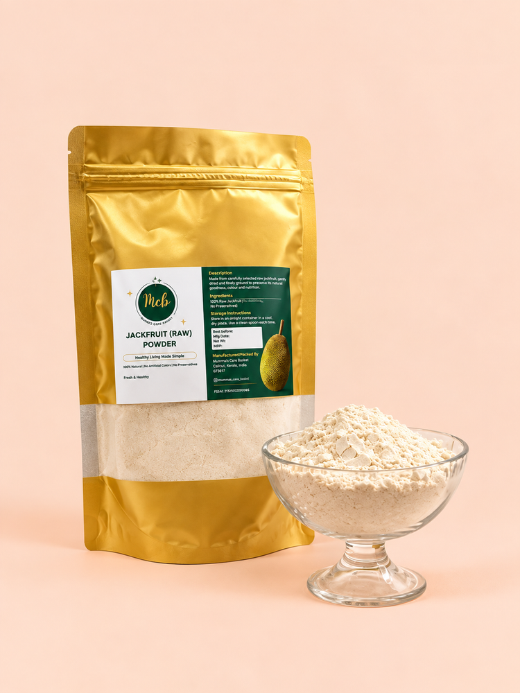 A gold stand-up pouch labeled 'Pdel Jackfruit (Raw) Powder' stands next to a small clear glass bowl filled with the light beige powder, set against a soft peach-pink background.